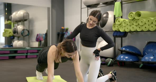 Young Woman Training at Gym with a Coach