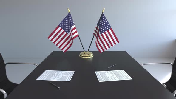 Flags of the United States and Papers on the Table alt