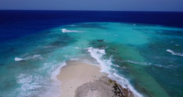 Natural above travel shot of a white sand paradise beach and blue water background in hi res 4K