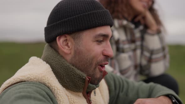 Smiling Man In Woolly Hat Laughing And Looking Away