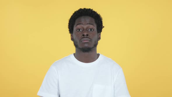 Yes African Man Shaking Head to Accept Yellow Background