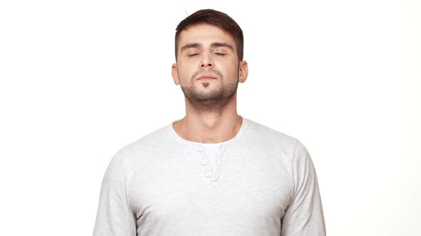 Strong Caucasian Male with Light Bristle and Sweatshirt Inhaling and Exhaling Standing on White