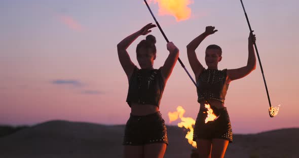 Fire Dancers Against Sunset
