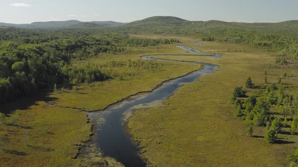 Spectacular aerial view ascending over lust green Union River, Eastern Maine scenery