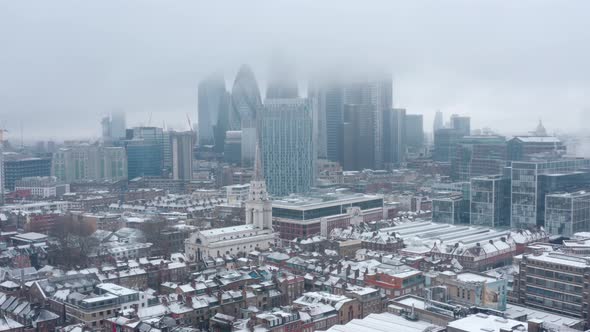 Cinematic rotating drone shot of City of London covered in snow