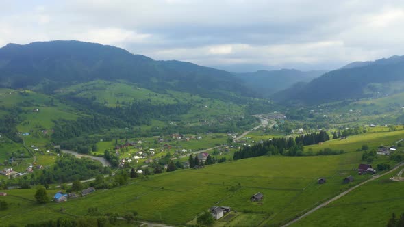 Aerial View of a Green Rural Area Under Blue Sky