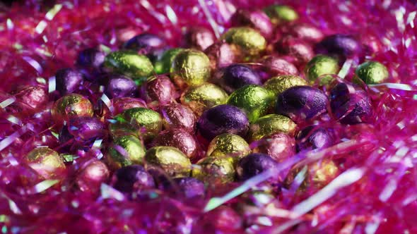 Rotating shot of colorful Easter candies on a bed of easter grass 