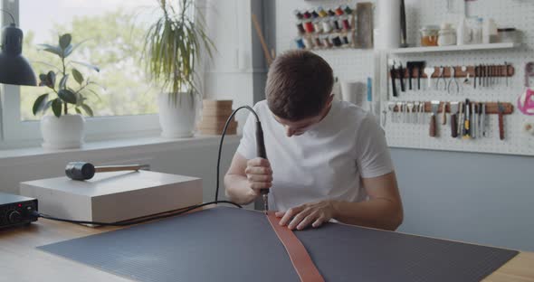 Using Electric Grooving Iron During Leather Belt Making Process