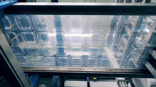 Bottom View of a Plastic Lid Production Line