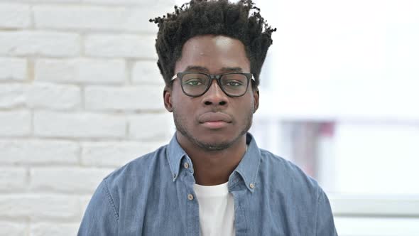 Young African Man Saying No with Finger Sign 