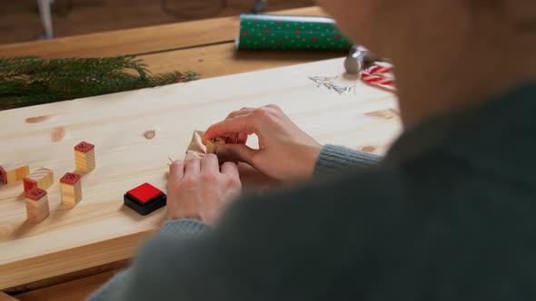 Woman Making Advent Calender on Christmas at Home