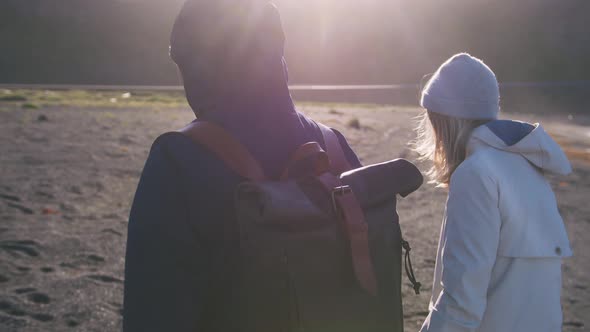 Close Up Shot of Young Loving Couple Running on Beach in Iceland During Sunset Slow Motion