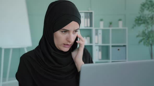 Busy Serious Islamic Muslim Businesswoman Typing Laptop Unexpected Call Answer Phone Calling Talking