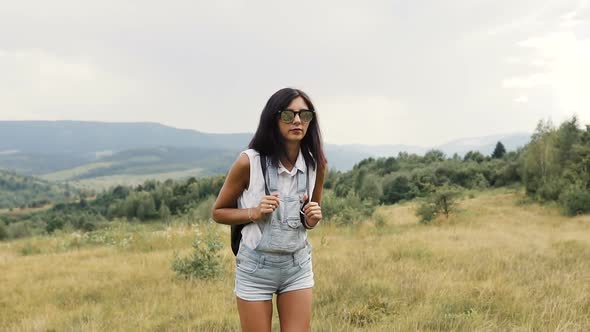 Girl Travels Mountains with a Backpack