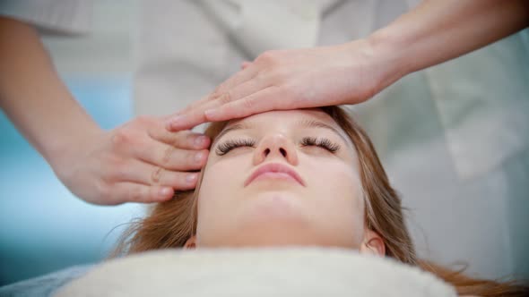 Massage - a Masseuse Is Kneading Her Clients Forehead