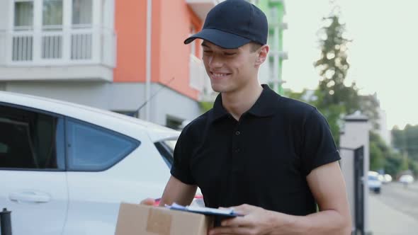 Courier Delivering Package To Client Outdoors