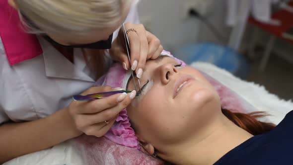 Professional Beautician Undergoing Eyelash Extension Procedure