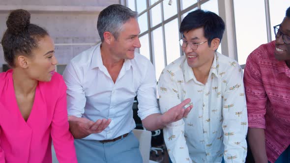 Multi-ethnic business colleagues interacting with each other in office 4k