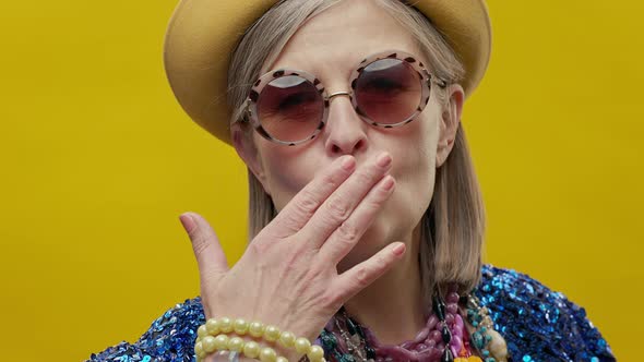 Stylish Elderly Woman On Yellow Background