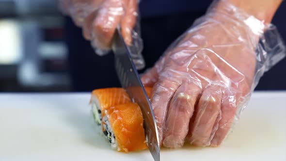 Making Sushi At Restaurant. Chef preparing delicious healthy sushi at restaurant