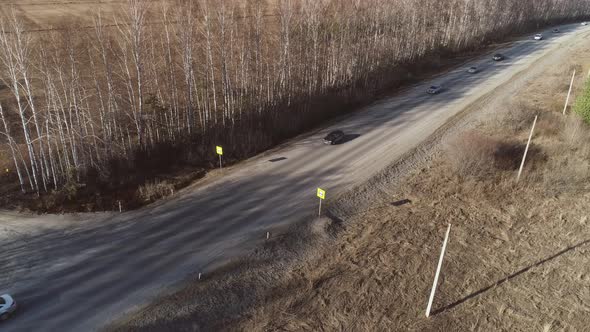 Aerial view of trucks and cars are driving along the spring road 15