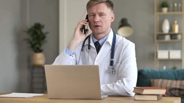 Businessman Talking on Phone While Lying in Bed