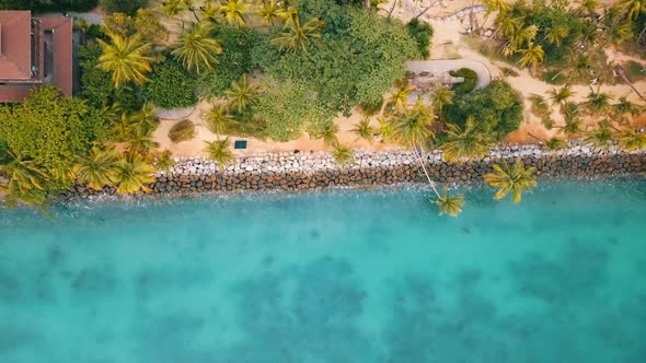 crystal blue water waves hitting the rocks at the beach of Palawan Islands / Santosa Island in Singa