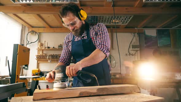 Slow Motion of a Woodworker Polishing a Wooden Block