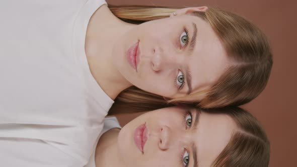 Vertical Portrait of Beautiful Twin Girls Posing