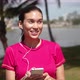 Casual Woman Listening to Music on Smartphone on Lakeside - VideoHive Item for Sale
