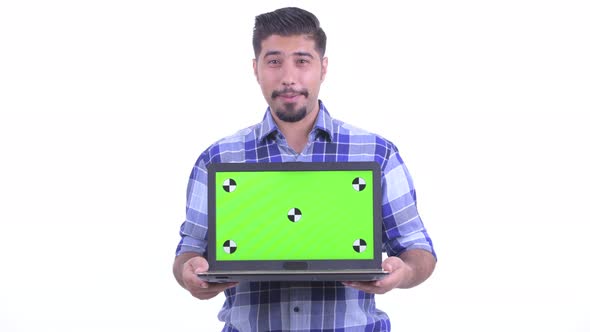 Happy Bearded Persian Hipster Man Talking While Showing Laptop