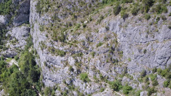 Aerial Shot of Hikers Paths on Slope of Mountains in Summer Day, Camera Is Flying Up, Showing