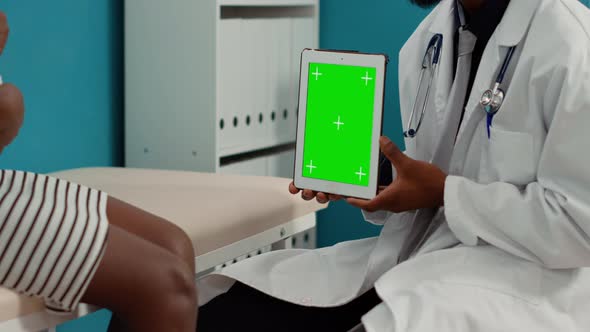 General Practitioner Holding Digital Tablet with Greenscreen