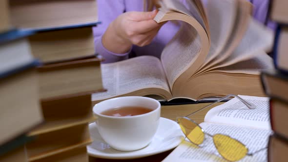 Female Hand Flipping Through the Pages of a Book Closeup