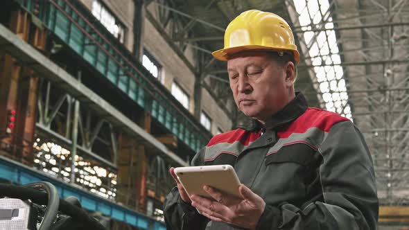 Plant Supervisor With Digital Tablet In Assembly Shop