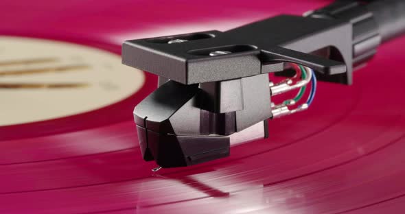 Pink Vinyl Record Spinning on Turntable