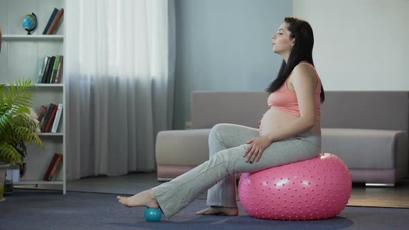 Gravid Lady Keeping Vlog for Future Moms Showing How to Soothe Feet After Stress