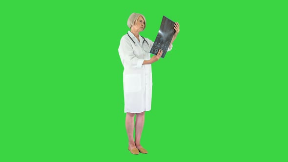 Female Specialist Checking Brain Tomography Results on a Green Screen Chroma Key