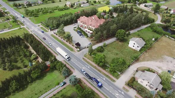 An Aerial Over a Charming Small Village Scene with Road and Hotel.