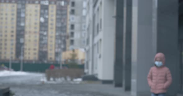 A Caucasian Girl Wearing Protective Mask Walking on a Street