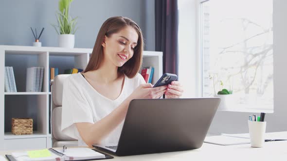 Young Woman Works at Home Office Using Computer.