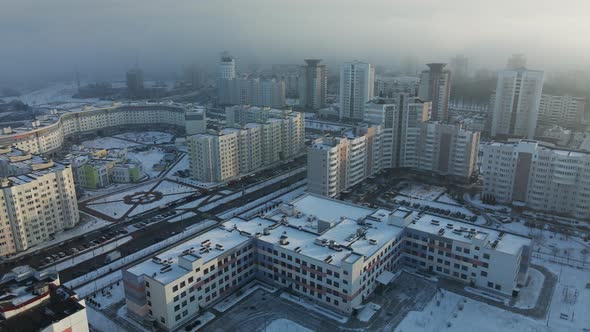 Flight over the city block. Modern multi-storey buildings.