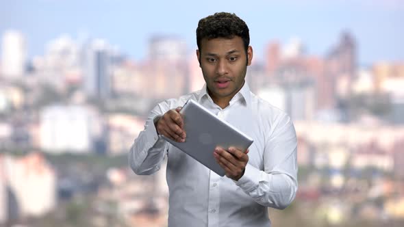 Businessman Playing Game on Digital Tablet