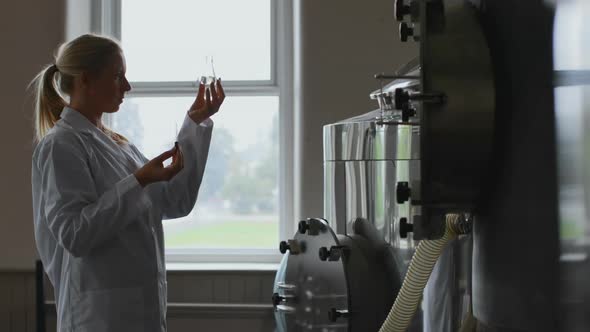 Female worker working in distillery factory 4k