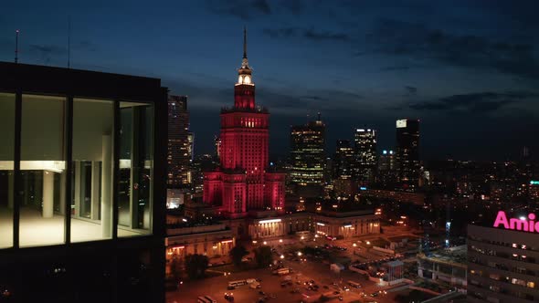 Panoramic View of Square and Red Lit Palace of Culture and Science at Night