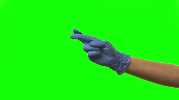 Doctors Female Hand in Blue Glove with Fingers Crossed, Pending