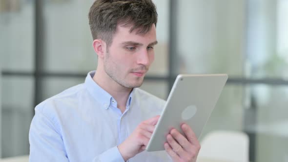 Portrait of Young Man Using Digital Tablet