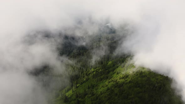 Aerial top view Landscape Above Mountains after rain. Drone Flying in Clouds