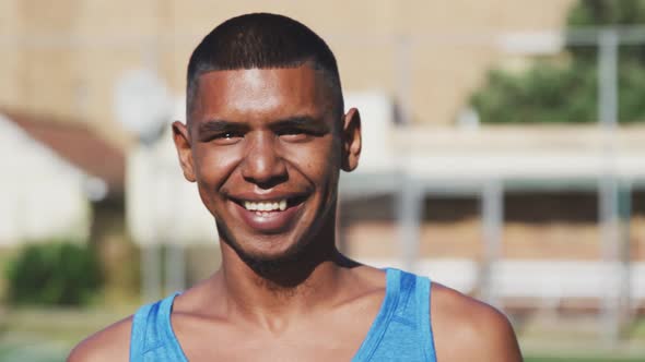 Soccer player smiling at camera on the field