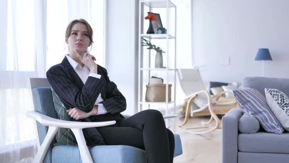 Pensive Woman Thinking While Sitting on Sofa